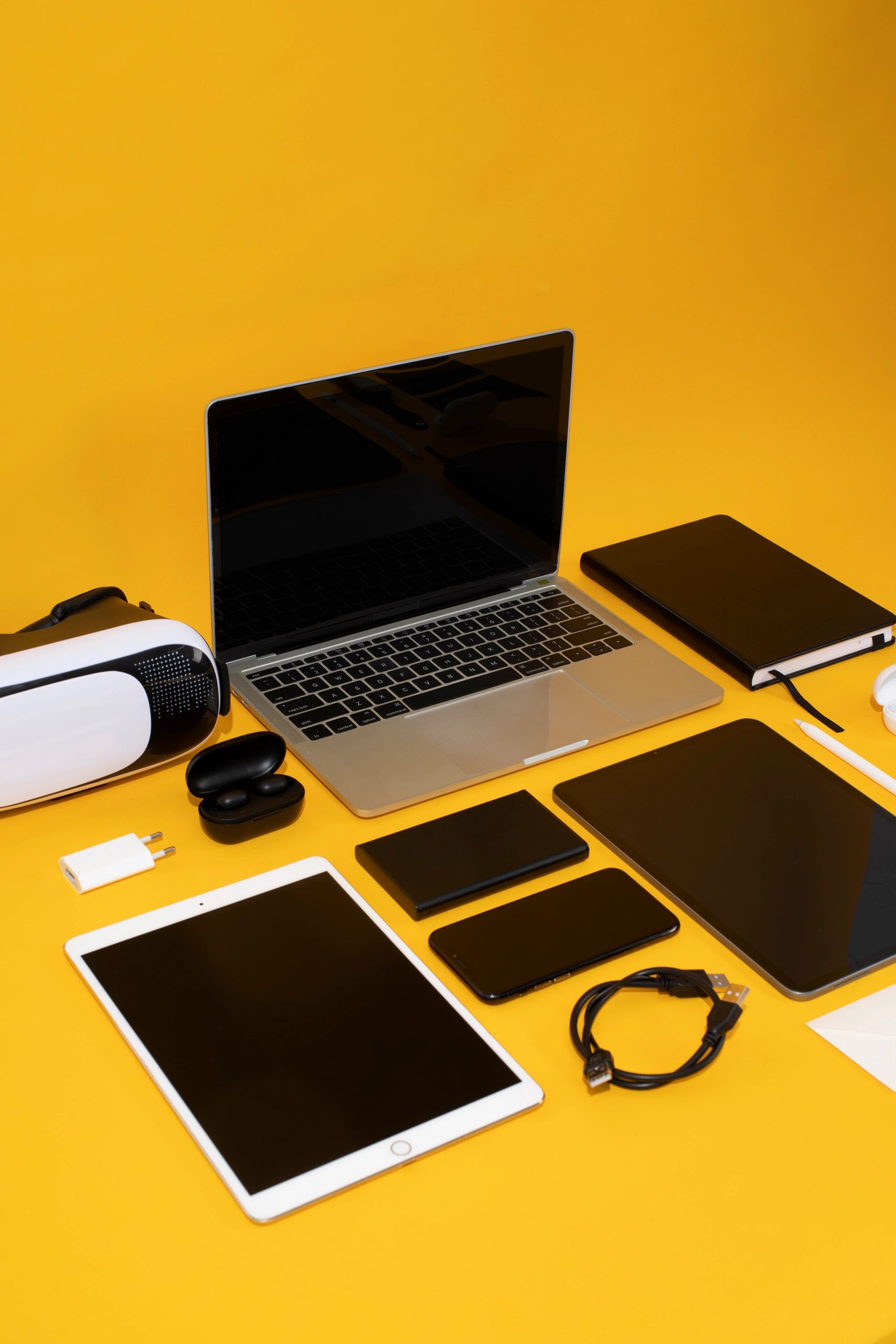 Tech devices including laptop, tablet, and phone