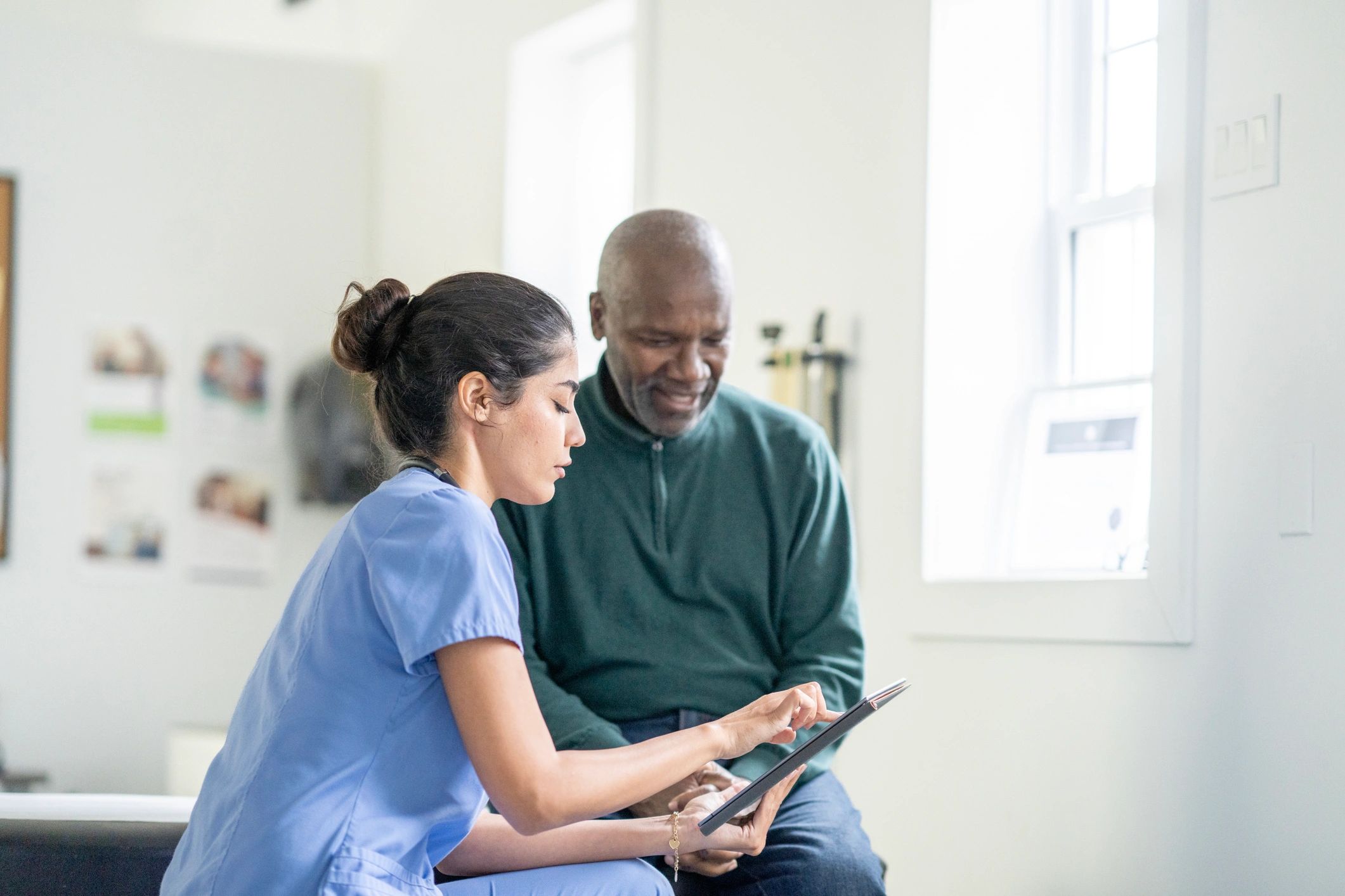 Healthcare worker and patient reviewing information on a tablet